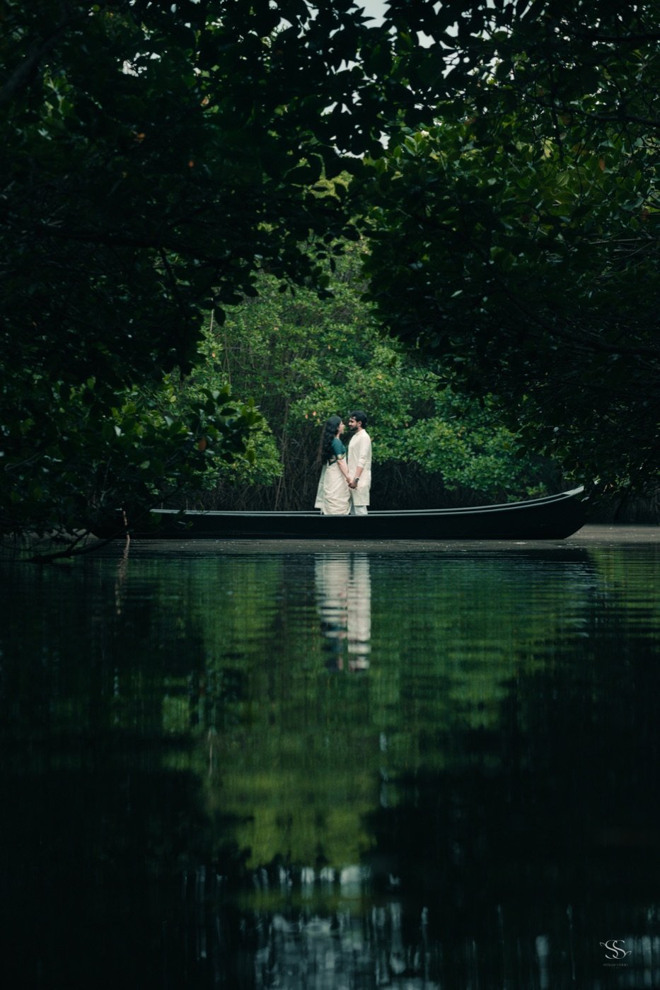 Standing together in a boat on green backwaters