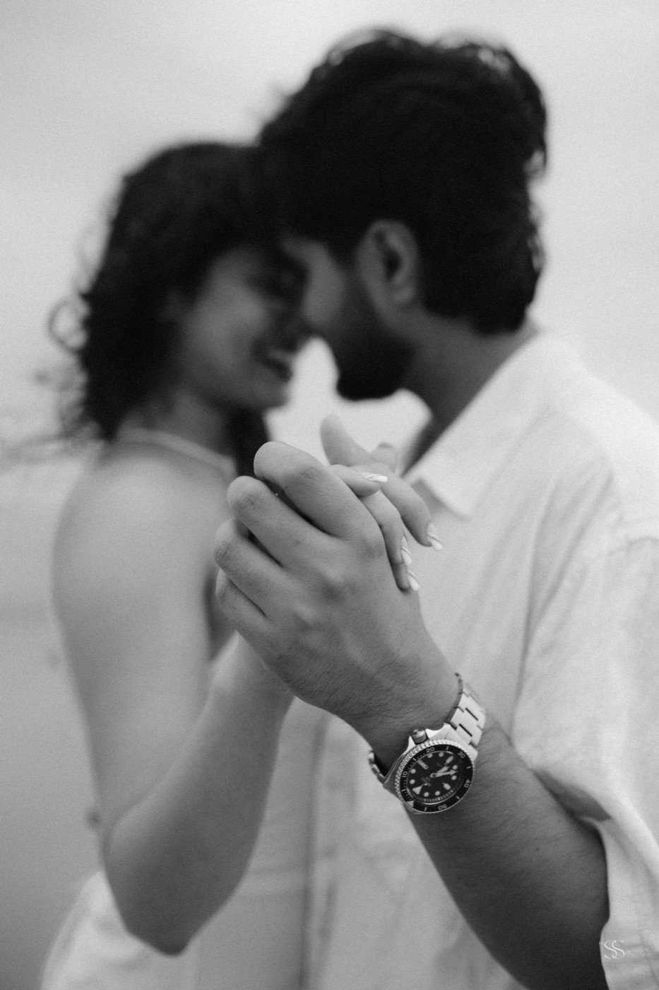 Held hands and a watch, black and white