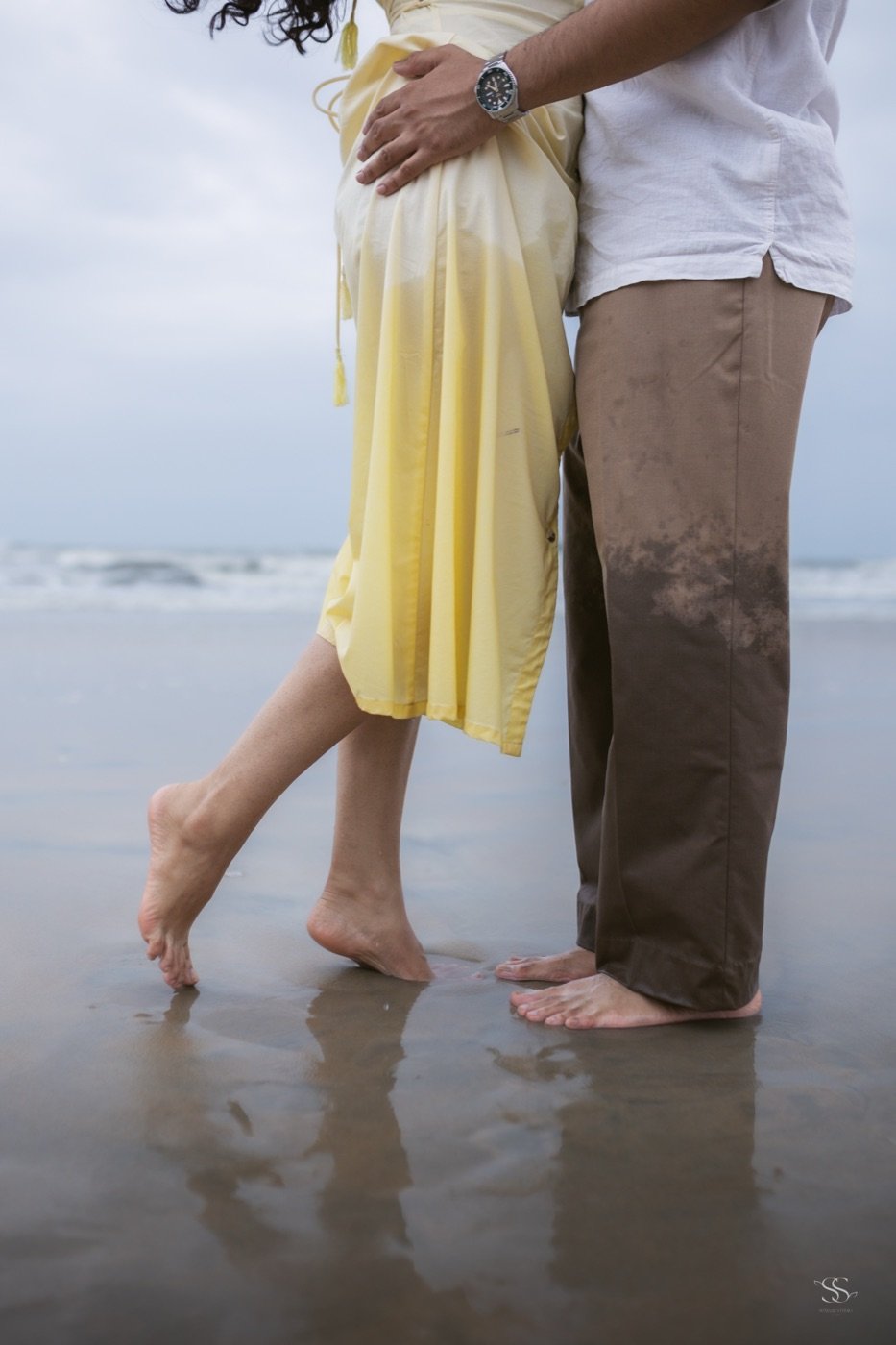 Bare feet at the edge of the surf